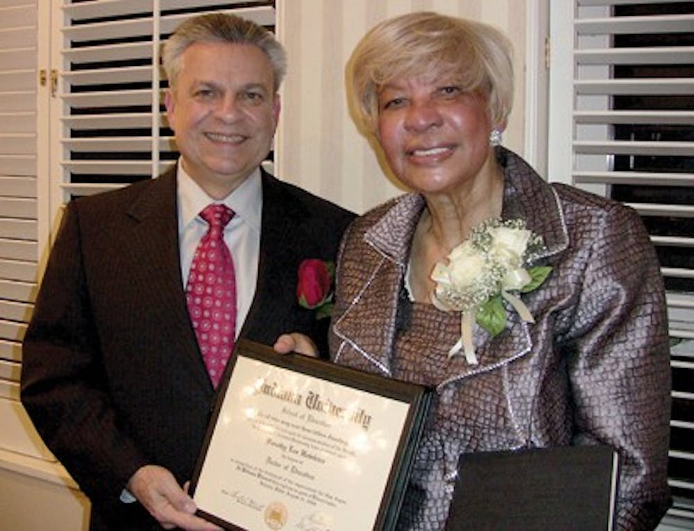 COURTESY PHOTOGerardo Gonzalez, dean of the IU School of Education, presents 1968 Alumna Dorothy Hawkins-Brooks with a replacement diploma after the original one was lost during Hurricane Katrina.