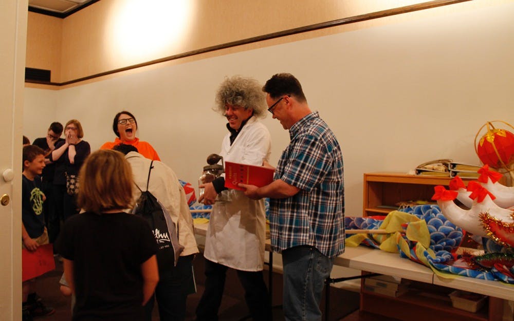 Director Jason Baird Jackson unmasked facilities manager Kelly Wherley, the culprit behind the missing butter churn at the "Mystery at the Museum" event Sunday afternoon at Mathers Museum of World Cultures.&nbsp;