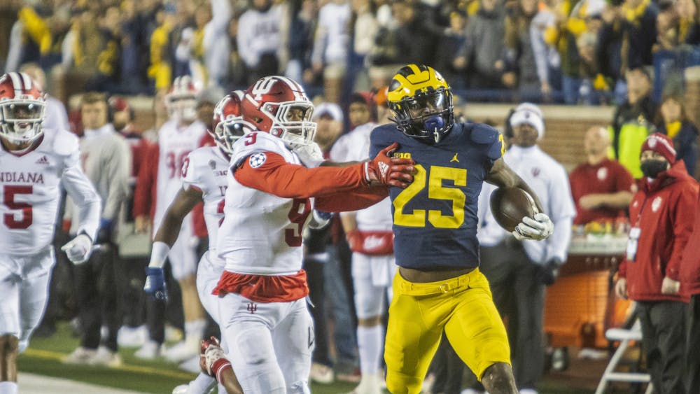 Redshirt senior devensive back Marcelino Mccrary-Ball tackles Michigan senior running back Hassan Haskins Nov. 6, 2021 at Michigan Stadium. Indiana's defense allowed Haskins to run for 168 yards and a touchdown Saturday.