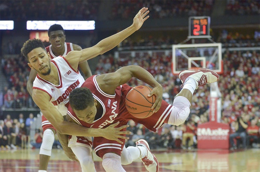 Senior guard Kevin "Yogi" Ferrell is fouled by a Wisconsin defender Tuesday at the Kohl Center. The Hoosiers lost 82-79 in overtime.
