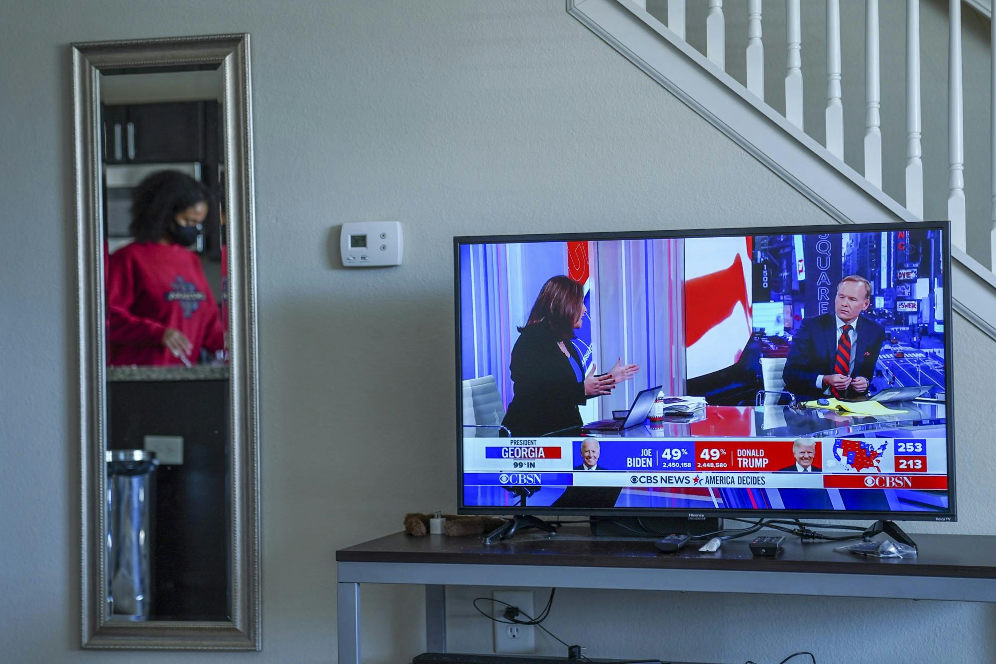 Aluko does the dishes and makes herself some tea as she listens to CBS News. During this time, the presidential election was too close to call in certain states such as Georgia.