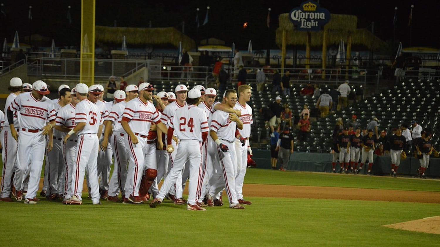 Teammates throw thier arms around Freshman Matt Gorski's neck and congratulate him for his game winning hit Tuesday night. After 10 innings the Hoosiers beat Ball State 4-3. 