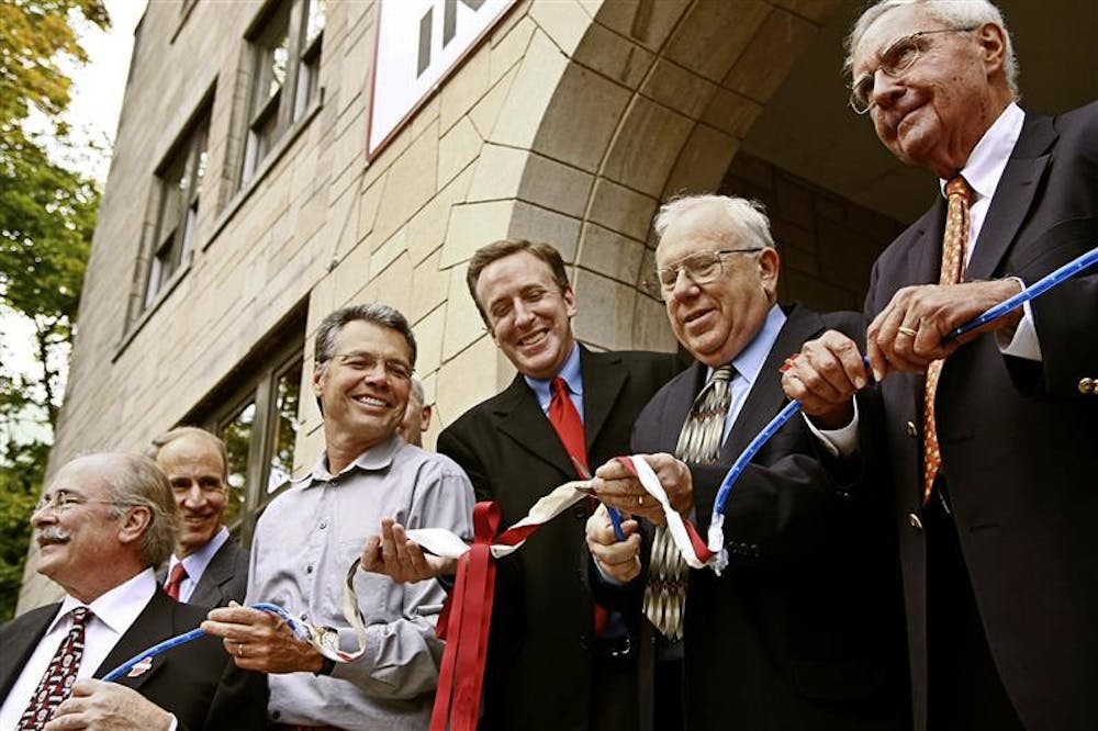 Professor Emeritus of Informatics Michael Dunn cuts the ribbon Friday afternoon at the new School of Informatics. Mayor Mark Kruzan also turned out for the celebration.