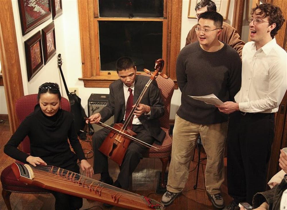 Graduate student Ochmaa Escue, local high school Delgerbat Uvsh, graduate student Benjamin Hahn and junior Chris Williams perform Friday evening at The Venue at 114 S. Grant St.. Part of a Mongolian New Year celebration, the song they performed is "telling others to love and serve parents while they still can," said Williams.