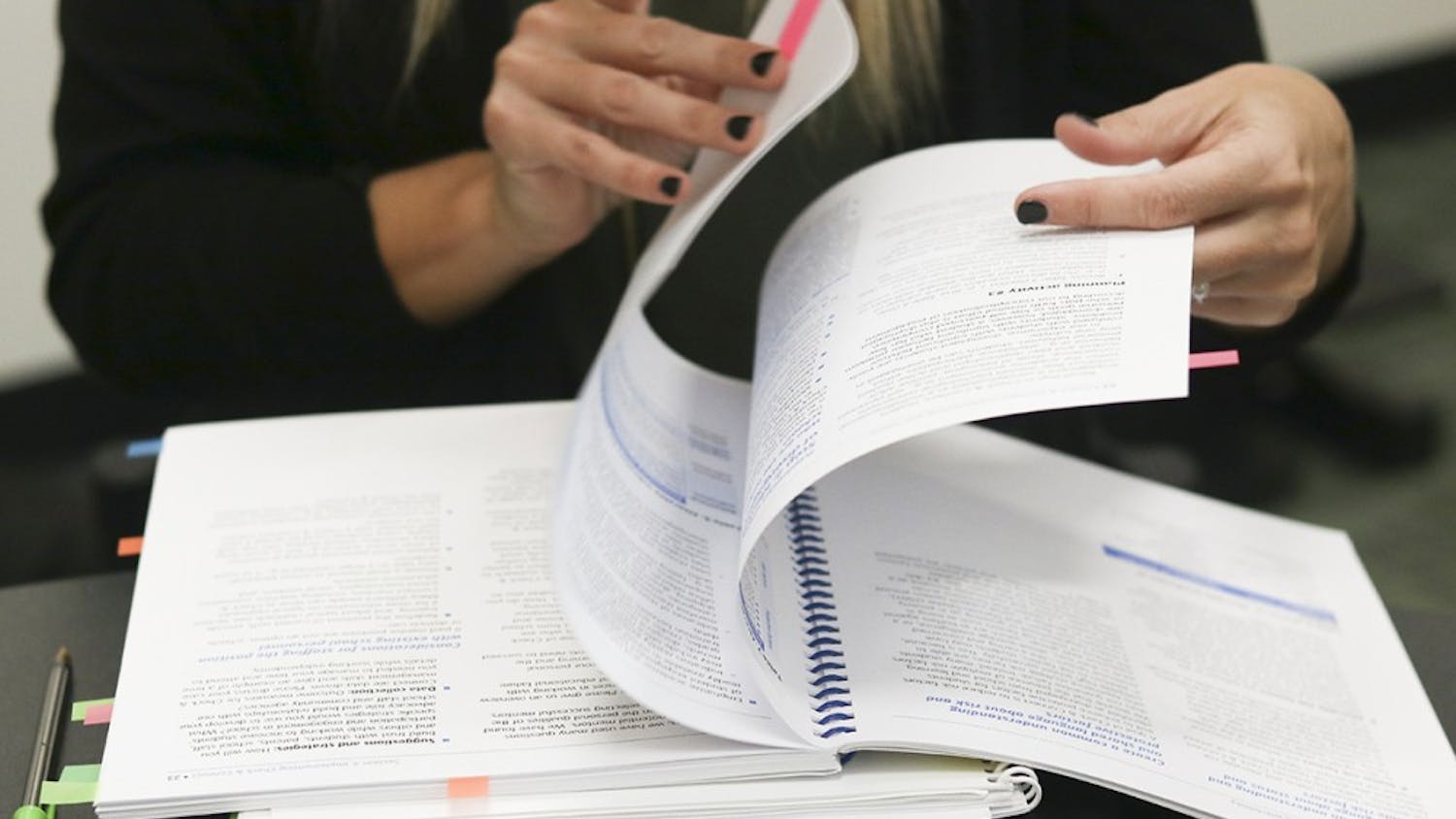 Trudy Shaw, director of second initiatives at Ivy Tech Bloomington, flips through her notebook to find the checklist she gives to students struggling with finances. 