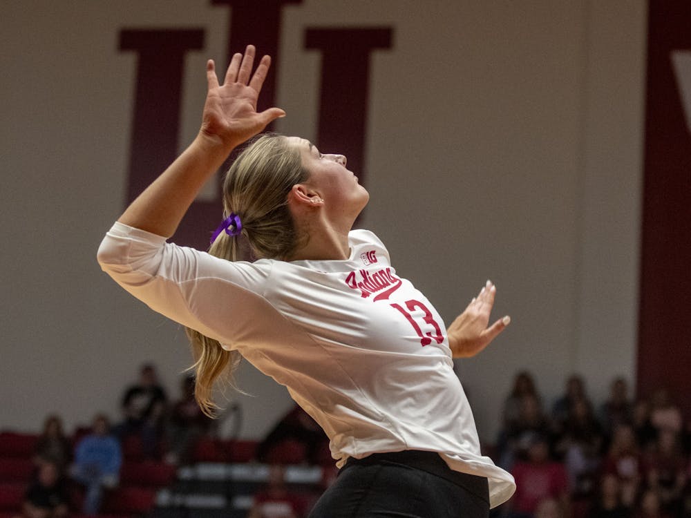 Sophomore middle blocker Avry Tatum jumps to hit the ball Sept. 29, 2023, against Iowa at Wilkinson Hall in Bloomington. Indiana won in three sets.