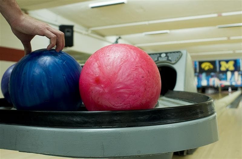 Students bowl Thursday evening in the Back Alley at the IMU. IMU officials are considering recommendations to replace the bowling alley. 