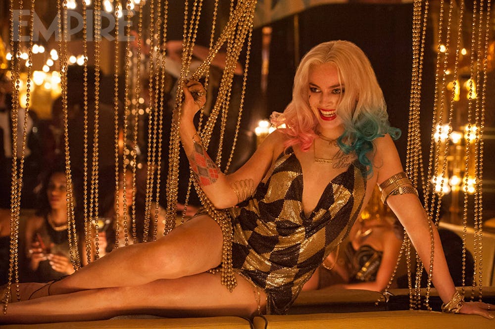 Actress Margot Robbie sits down in the movie "Suicide Squad."