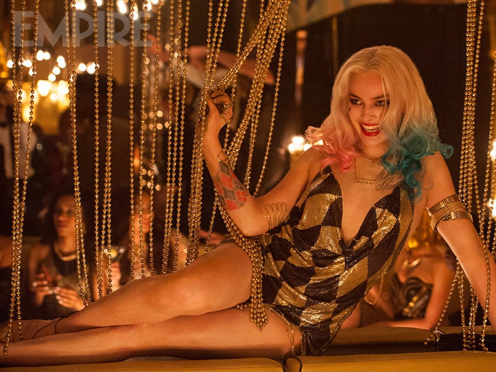 Actress Margot Robbie sits down in the movie "Suicide Squad."