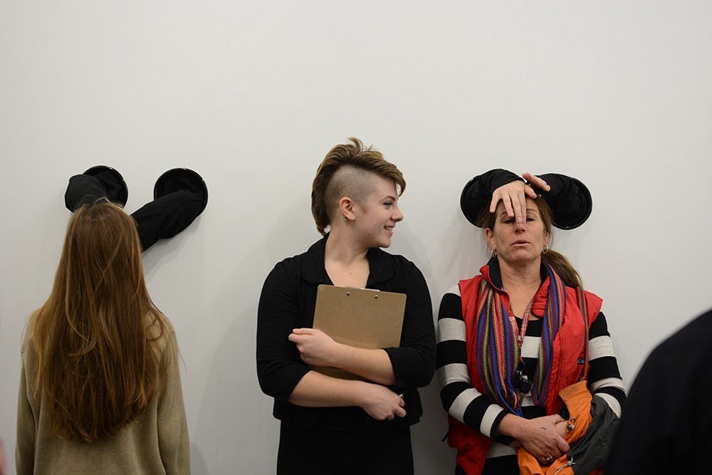 Grace and Bobbie Saccone get their faces touched by BFA students as the students attempt to sculpt their faces. Grace said her sister is one of the students making the sculpure. 