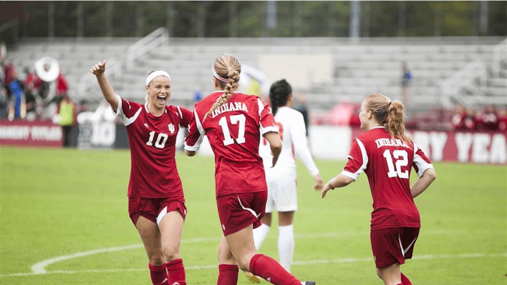 Rebecca Candler celebrates with teammates after a goal on Oct. 6 at Bill Armstrong Stadium. Candler is closing in on the all-time school record for assists in a career.