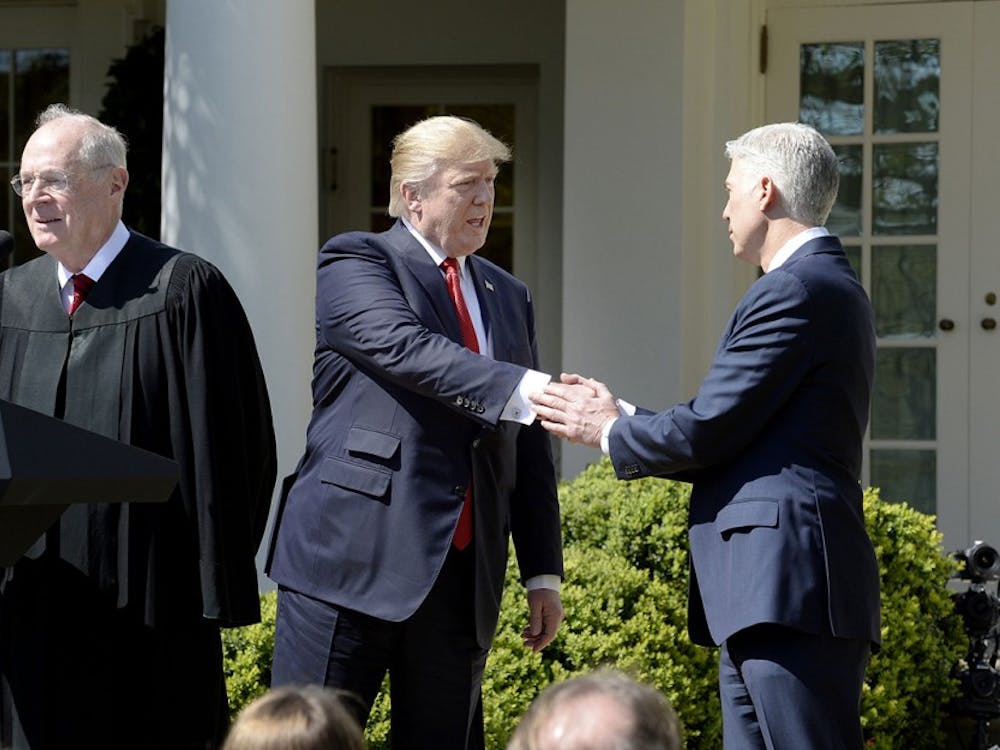 Justice Anthony Kennedy speaks as President Donald trump shakes hands with Neil Gorsuch ibefore a swearing in ceremony at the White House Rose Garden April 10, 2017 in Washington, D.C. (Olivier Douliery/Abaca Press/TNS) 