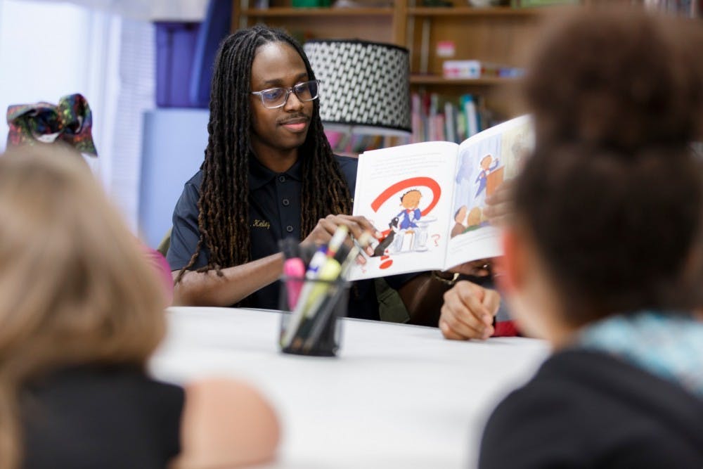 <p>IU alumnus Tyler Kelley reads at the alumni chapter of Alpha Phi Alpha&#x27;s weekly reading group at The Rise. Kelley started the program, which provides transitional housing and resources for families affected by violence.</p>