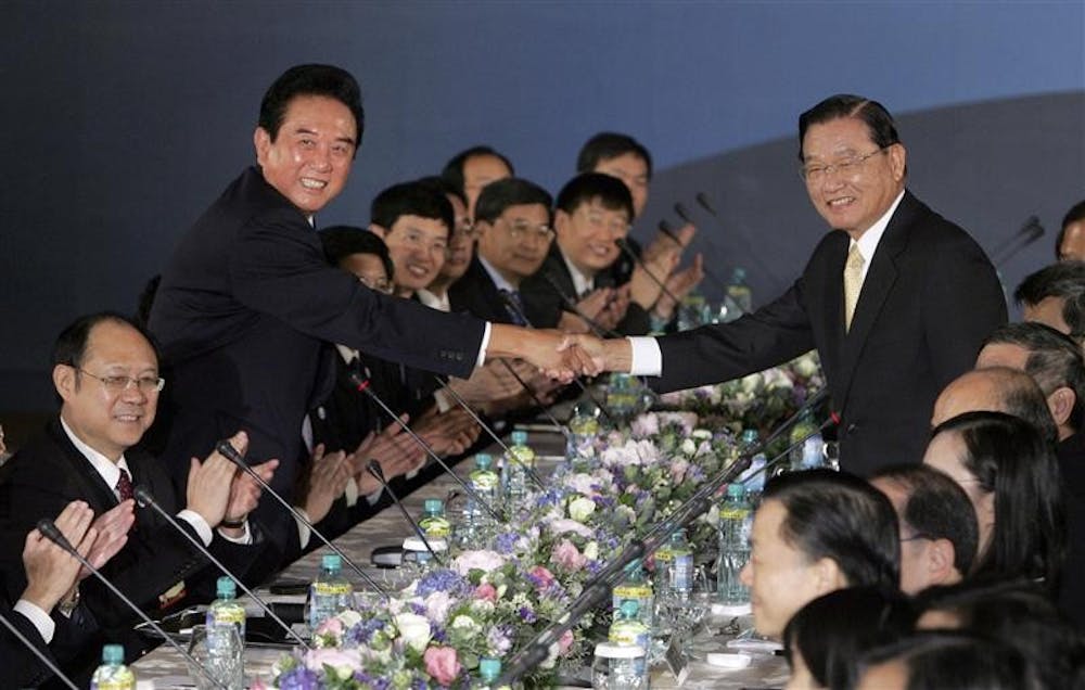 China's top negotiator with Taiwan, Chen Yunlin, standing at left, shakes hands with his Taiwan counterpart Chiang Ping-kung at the start of direct meetings on Tuesday in Taipei, Taiwan. The highest-ranking Chinese official to visit Taiwan in six decades has begun talks with his Taiwanese counterpart on a sweeping trade pact that could help ease the threat of war between the rivals.