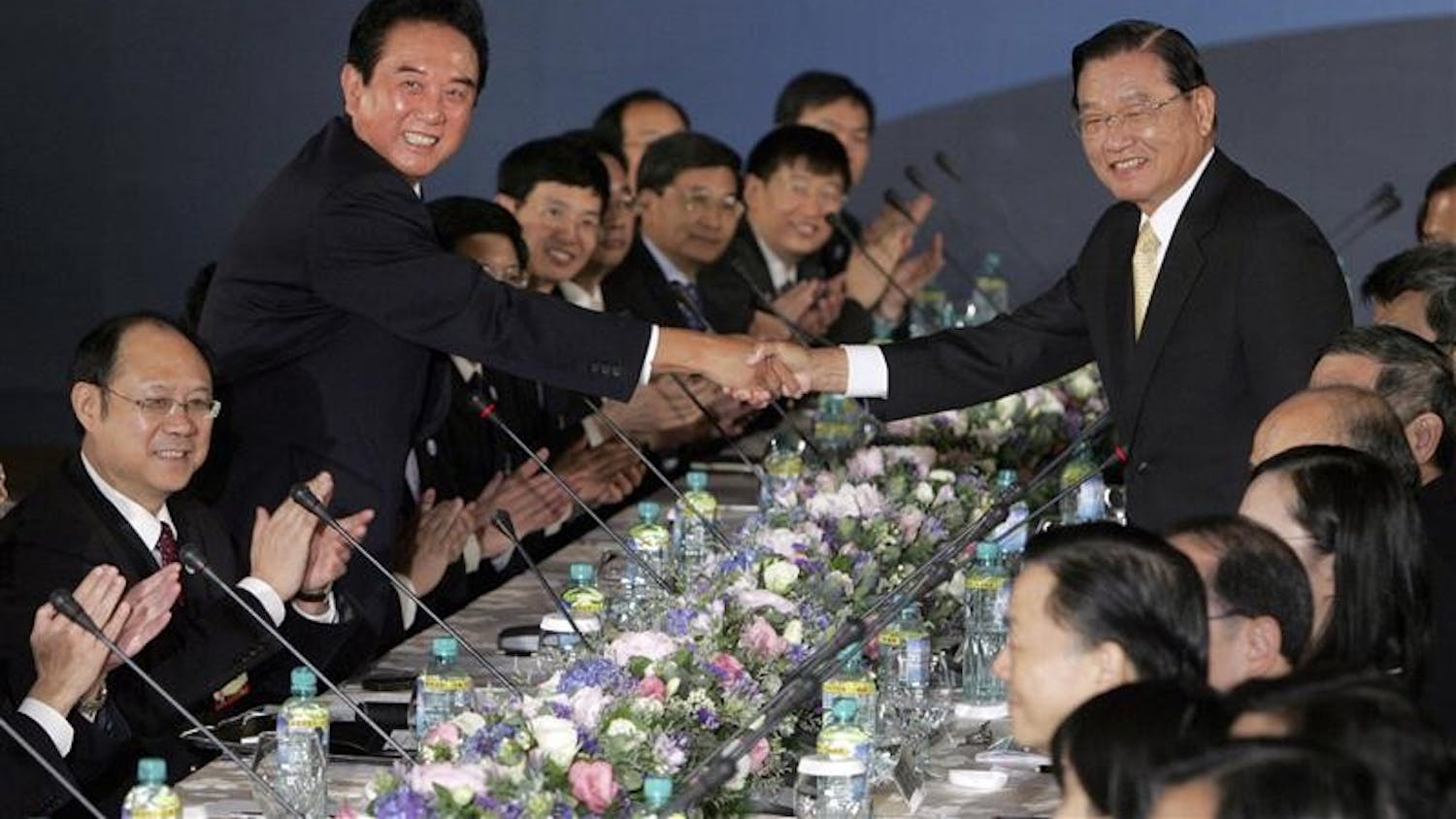 China's top negotiator with Taiwan, Chen Yunlin, standing at left, shakes hands with his Taiwan counterpart Chiang Ping-kung at the start of direct meetings on Tuesday in Taipei, Taiwan. The highest-ranking Chinese official to visit Taiwan in six decades has begun talks with his Taiwanese counterpart on a sweeping trade pact that could help ease the threat of war between the rivals.
