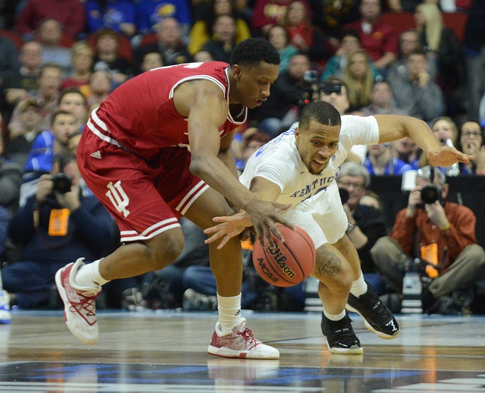 Kentucky freshman guard Isaiah Briscoe attempts to steal the ball from junior forward Troy Williams  during the NCAA second round game Saturday at the Wells Fargo Arena in Des Moines, Iowa.