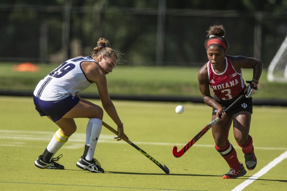<p>Senior Taylor Swope dribbles past Northwestern’s Puck Pentenga during the match on Sept. 14 at the IU Field Hockey Complex.&nbsp;</p>