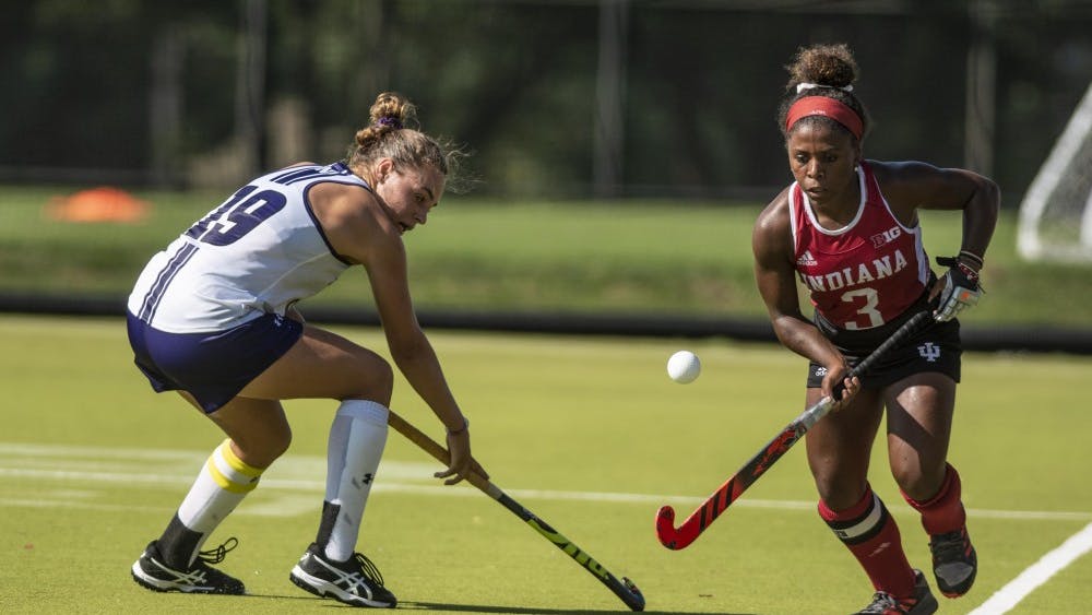 Senior Taylor Swope dribbles past Northwestern’s Puck Pentenga during the match on Sept. 14 at the IU Field Hockey Complex.&nbsp;
