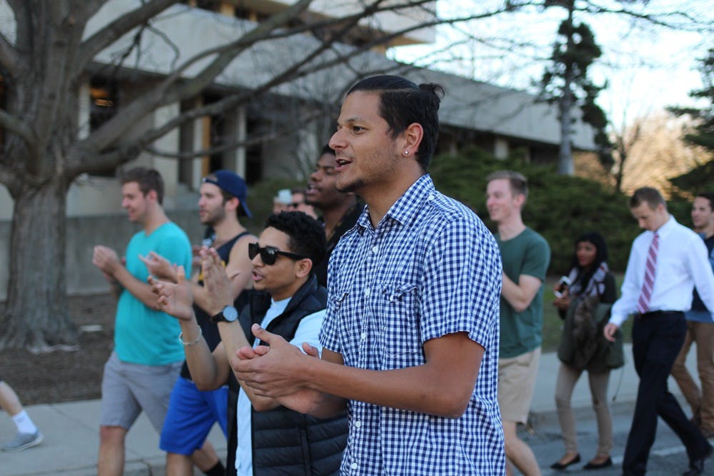 Kaleb Sullen (right), senior brother at Sigma Alpha Epsilon and co-organizer of Unity March IU and Cameron Harris (left), brother at Alpha Phi Alpha Fraternity Inc., chant "I-Unify" with the crowd as they walk down Jordan Ave. on Tuesday. "There are a lot of greeks out here but this is about everybody getting together and showing support," Sullen said during his speech.       