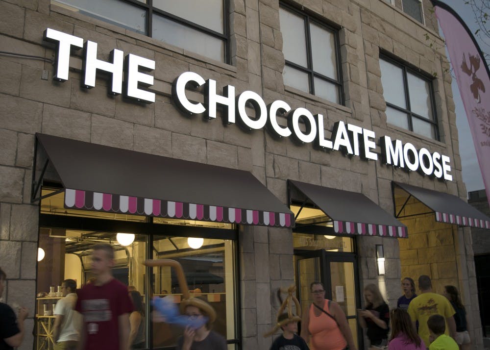 The new Chocolate Moose storefront glows bright during the grand reopening Sunday night. Although the 401 S Walnut St. location remains the same, the original stand was torn down in November for a new apartment complex to be built overhead.