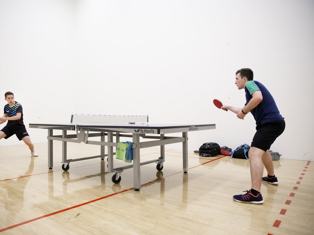 Freshman Sharon Alguetti, right, practices table tennis Aug. 8 with his brother, Gal, at the Student Recreational Sports Center. The brothers are trying to qualify for the 2020 Tokyo Olympics this year. CORRECTION: A previous version of this caption misidentified the brothers. The IDS regrets this error.