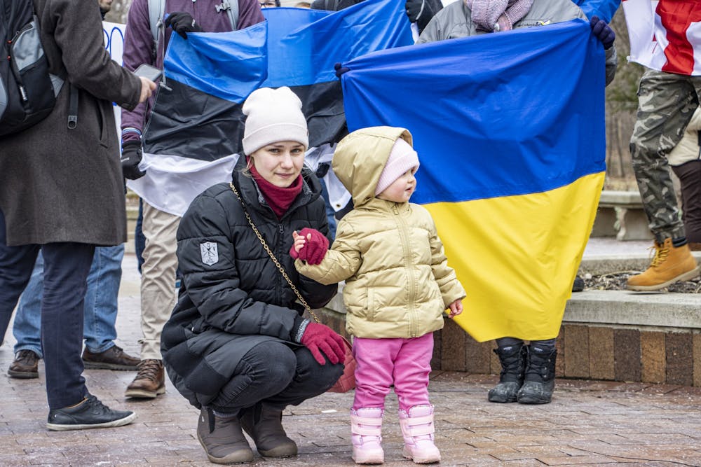<p>Ukrainian national Alla Chebanenko looks on with one of her daughters during a protest on Feb. 25, 2022, at the Sample Gates. Reuters reported Monday that at least 406 civilians have died in Ukraine since the start of the invasion. </p>
