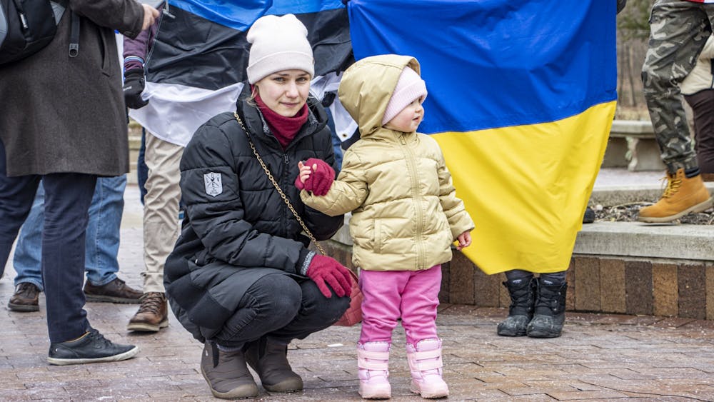Ukrainian national Alla Chebanenko looks on with one of her daughters during a protest on Feb. 25, 2022, at the Sample Gates. Reuters reported Monday that at least 406 civilians have died in Ukraine since the start of the invasion. 