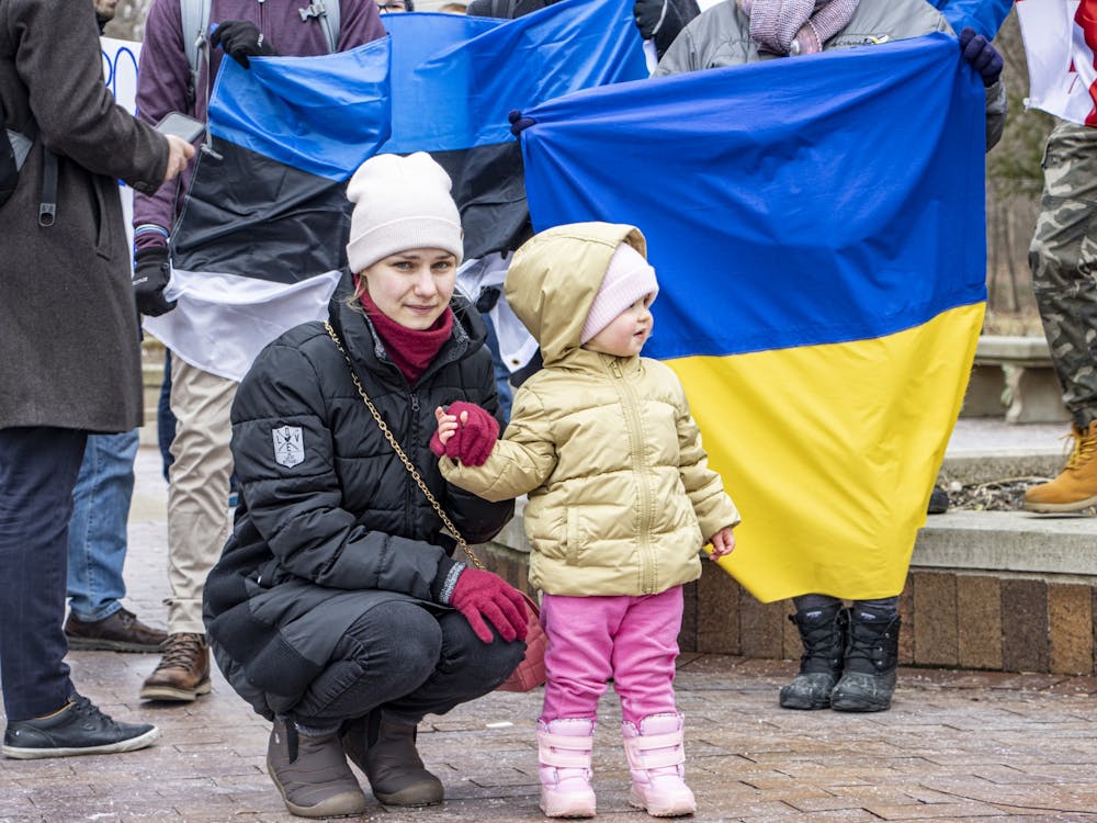 Ukrainian national Alla Chebanenko looks on with one of her daughters during a protest on Feb. 25, 2022, at the Sample Gates. Reuters reported Monday that at least 406 civilians have died in Ukraine since the start of the invasion. 