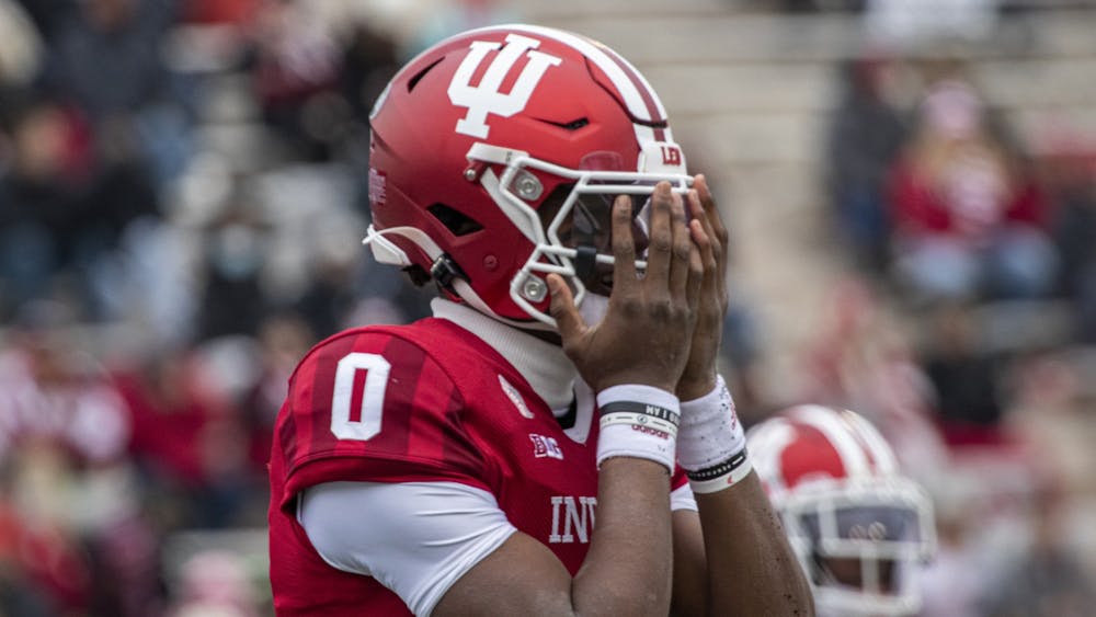 IU freshman quarterback Donaven McCulley covers his face after fumbling the opening snap of the game against Rutgers on Nov. 13, 2021, at Memorial Stadium. Indiana lost four fumbles and threw two interceptions against Rutgers.