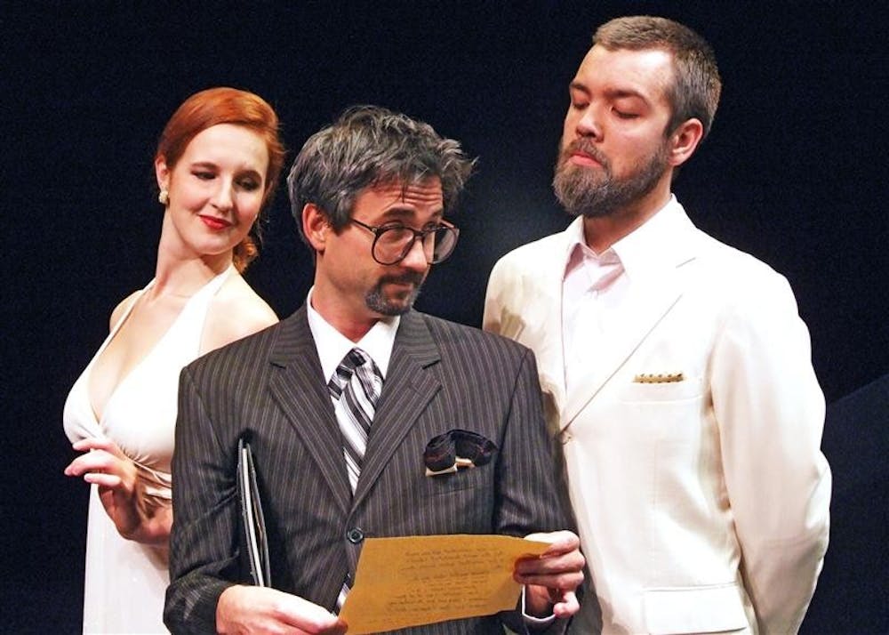 Polonius (Neil Utterback, center) reads a disturbing letter from Hamlet to Gertrude (Bethany Barber, left), and Claudius (Josh Hambrock) in the IU Department of Theatre and Drama's production of Hamlet in the Ruth N. Halls Theatre.