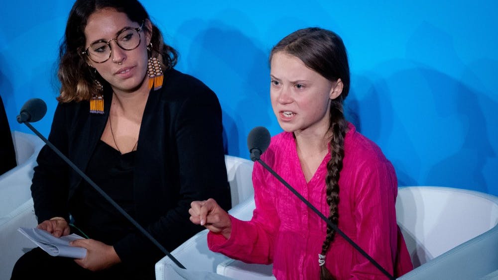 Climate activist Greta Thunberg, right, speaks at the United Nations Climate Change Conference on Sept. 23 in New York City. President Donald Trump mocked Thunberg in a tweet Monday night.