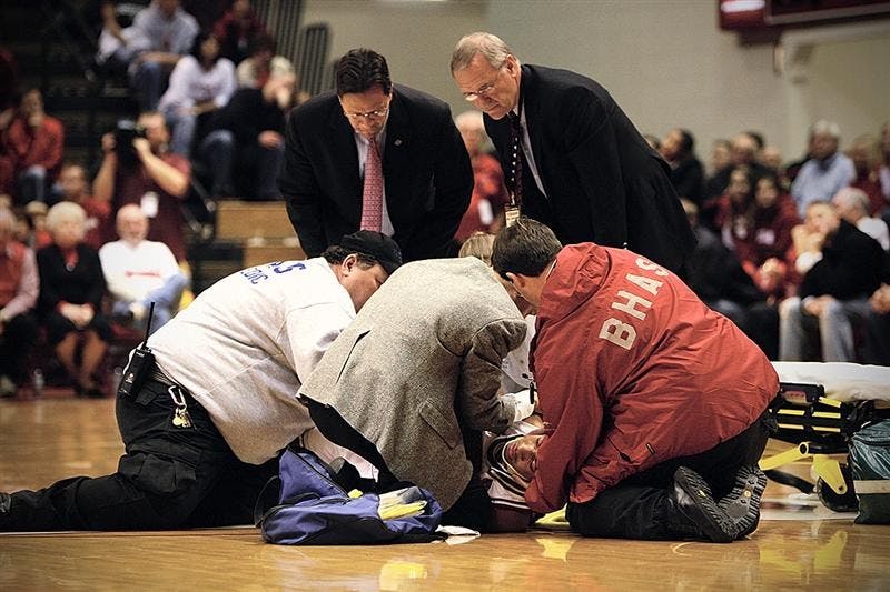 Emergency personnel attend to freshman guard Verdell Jones following a hard fall on to the Assembly Hall floor during the first half of the Hoosiers game against Cornell. Jones was fitted with a neck support brace and then removed from the court on a stretcher.