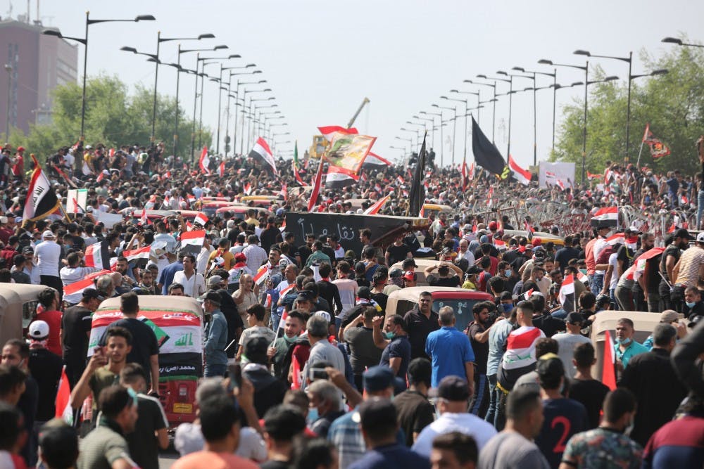 Protesters try to cross al-Jumhouriya bridge to reach the Green Zone on Oct. 25 in Baghdad. Hundreds of protesters rallied Friday in some Iraqi cities including capital Baghdad, amid the resumed anti-government demonstrations over unemployment, corruption and lack of public services. 