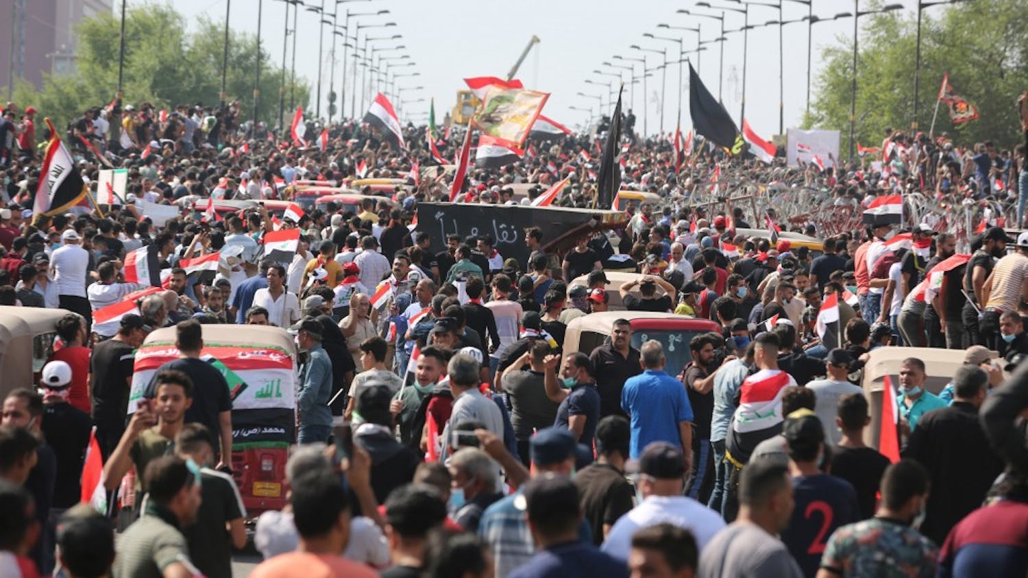Protesters try to cross al-Jumhouriya bridge to reach the Green Zone on Oct. 25 in Baghdad. Hundreds of protesters rallied Friday in some Iraqi cities including capital Baghdad, amid the resumed anti-government demonstrations over unemployment, corruption and lack of public services. 