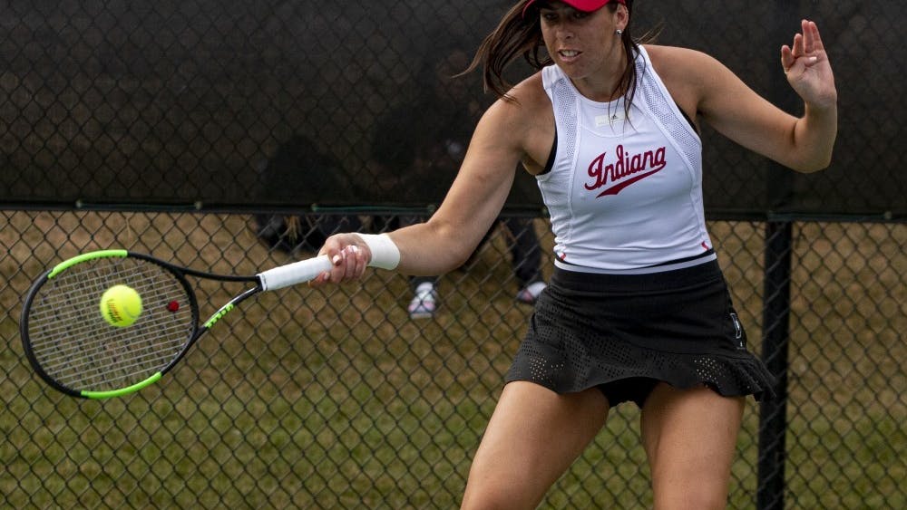 Graduate student Annabelle Andrinopoulous strikes the ball Sept. 29 at the IU tennis courts. Andrinopoulos spent her first four seasons at the University of Colorado before transferring to IU. 