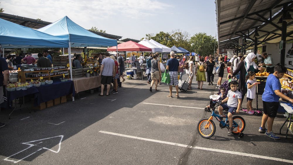 A crowd of people visit stalls Sept. 11, 2021, at the Bloomington Community Farmers’ Market. There will be a wide array of events and activities this Labor Day weekend.