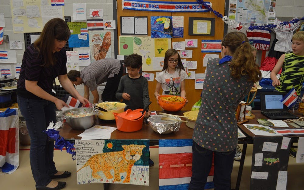 Students at Templeton Elementary School prepare food at a table that represented Costa Rica on Thursday evening. The event&nbsp;was part of a new program the elementary school is launching in partnership with&nbsp;Bridges called,&nbsp;Templeton Eats Global.