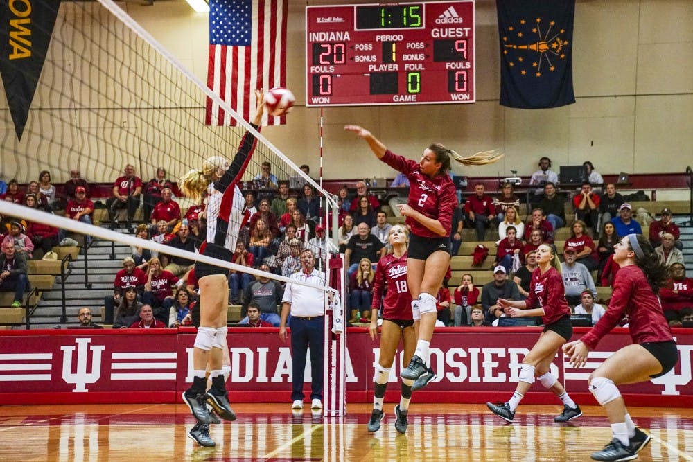 <p>Junior middle blocker Hayden Huybers returns the ball against a Rutgers defender Oct. 13 in University Gym. IU defeated Rutgers, 3-0.</p>
