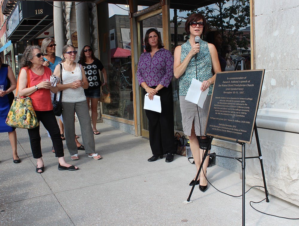 Cathi Crabtree, chair of the City of Bloomington Commission on the Status of Women, helps rededicate a plaque in memory of Susan B. Anthony's visit to Bloomington during the Women's Suffrage Movement. 