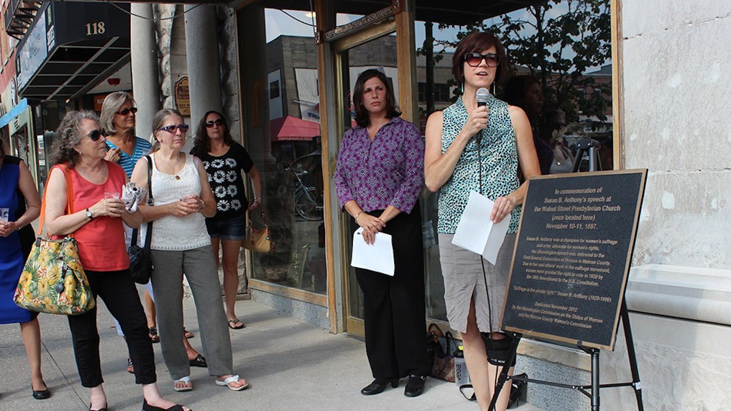 Cathi Crabtree, chair of the City of Bloomington Commission on the Status of Women, helps rededicate a plaque in memory of Susan B. Anthony's visit to Bloomington during the Women's Suffrage Movement.