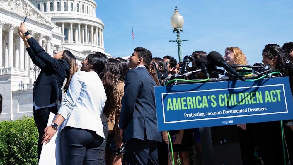 People take a selfie at a press conference in May 2022 in Washington, D.C., in support of the America&#x27;s Children Act, a proposed piece of legislation to help keep children of long term visa holders from having to leave the United States after they lose their dependent status once they turn 21. Lay and Khushi Patel, two IU students, traveled to Washington, D.C., to advocate for legislation that would provide a path to citizenship for students like them.