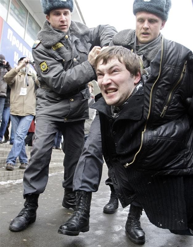 Police officers detain an activist from the Young Russia pro-Kremlin youth group for interrupting a sanctioned opposition rally on Saturday in Moscow. An anti-Kremlin rally organized by the Solidarity, a new Russian opposition movement, was held in downtown Moscow on Saturday.