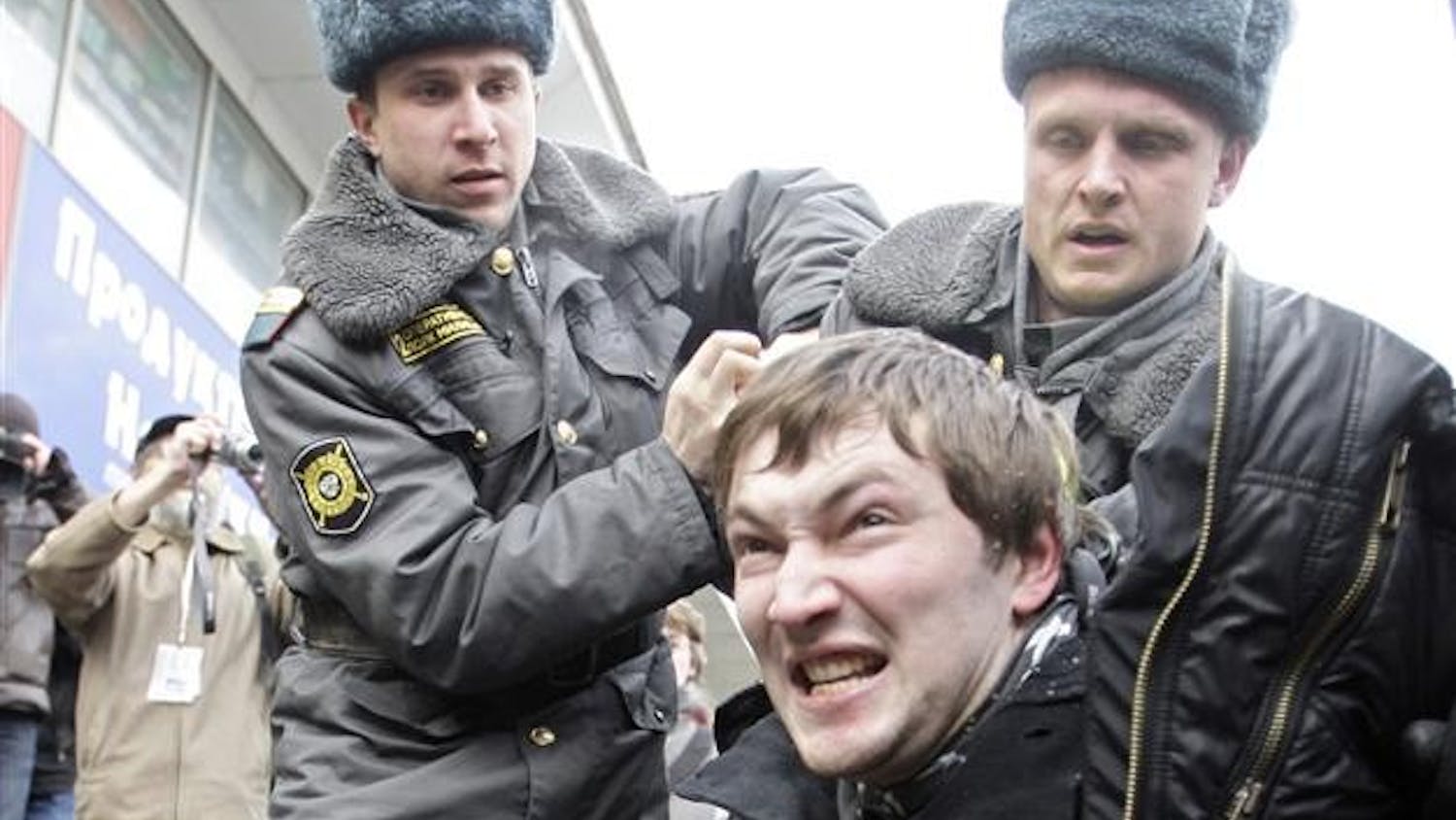 Police officers detain an activist from the Young Russia pro-Kremlin youth group for interrupting a sanctioned opposition rally on Saturday in Moscow. An anti-Kremlin rally organized by the Solidarity, a new Russian opposition movement, was held in downtown Moscow on Saturday.