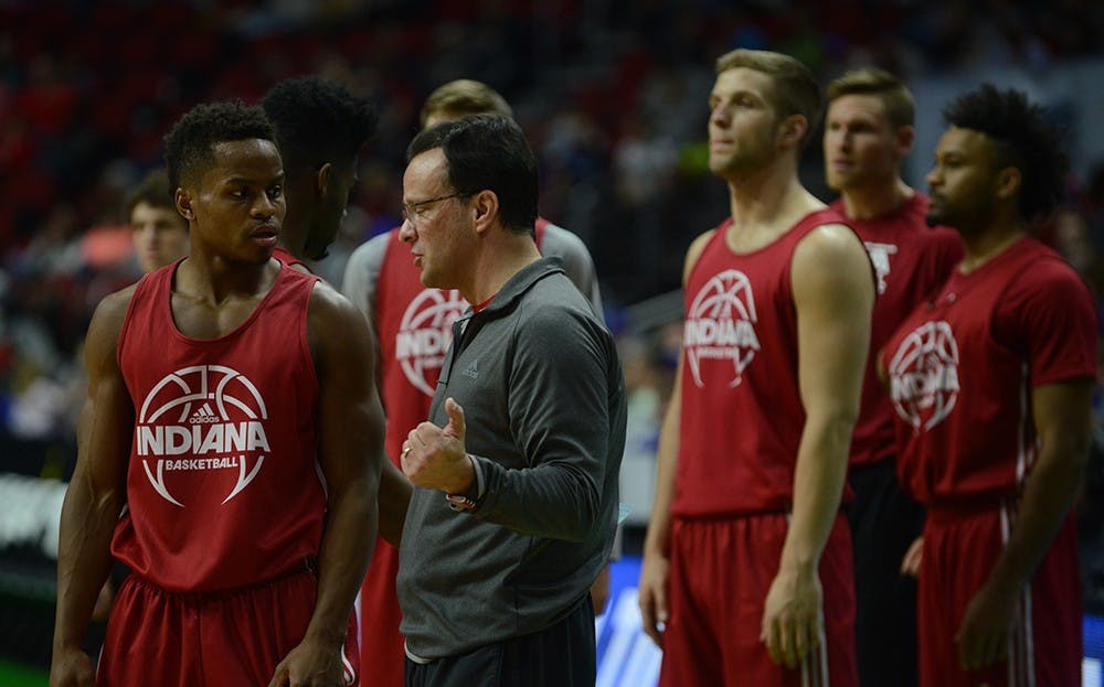 Coach Tom Crean talks to senior guard Yogi Ferrell during practice Wednesday before the Hoosiers face Chattanooga at the Wells Fargo Arena in Des Moines, Iowa.