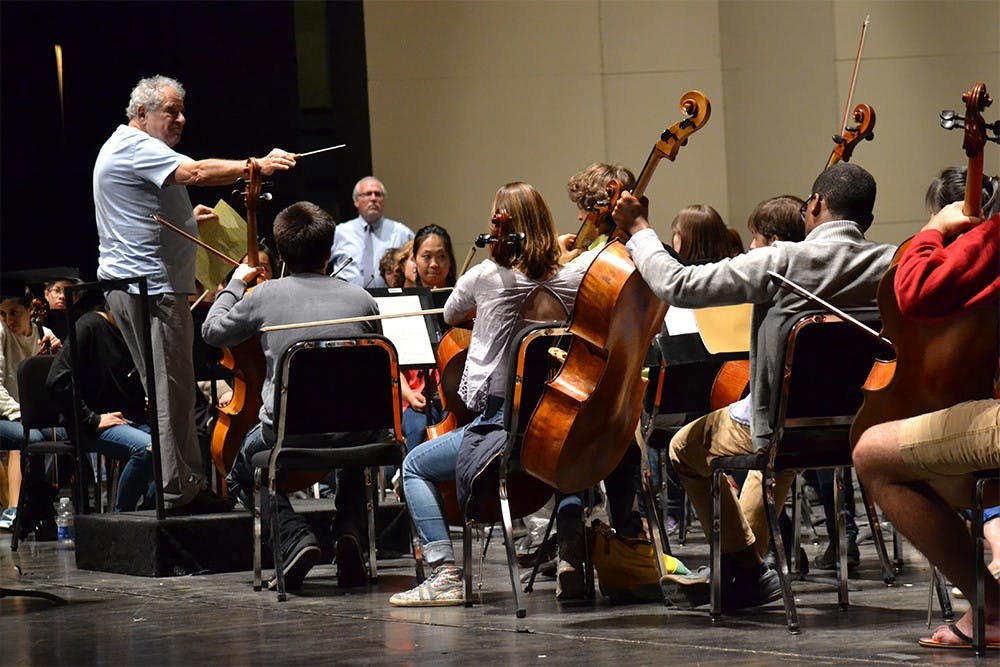 Conductor David Effron leads the University Orchestra during a practice on the Musical Arts Center's stage on Tuesday afternoon. The concert on Wednesday will be the first Effron has conducted this year.