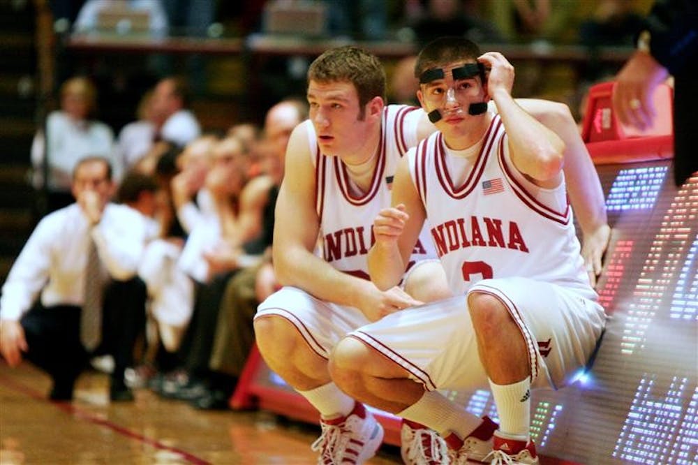 Tom Pritchard, left, and Daniel Moore wait to enter the game during IU's 103-71 win over Anderson on Friday at Assembly Hall.