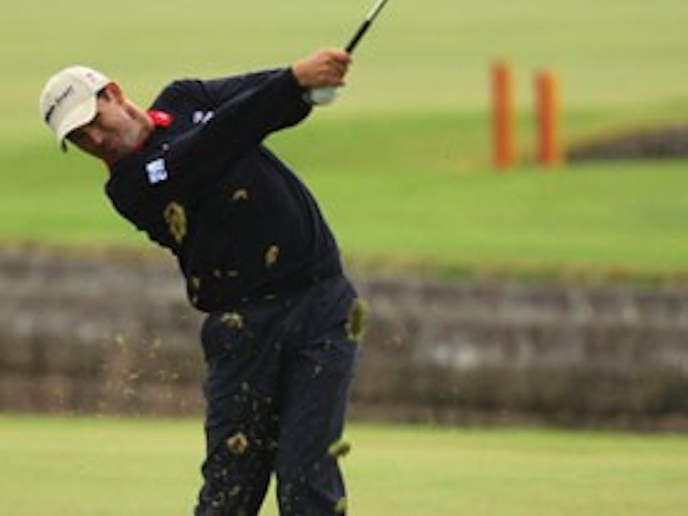 Ireland's Padraig Harrington makes a shot after playing into the water of the 18th hole during the final round of the British Open Golf Championship Sunday at Carnoustie, Scotland.  (AP Photo/Peter Morrison) ** EDITORIAL USE ONLY ** 