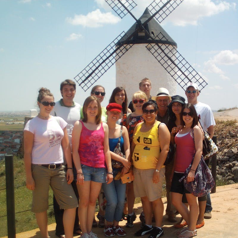 COURTESY PHOTOStudents take a group photo at the windmills of Consuegra, Spain during their four-week trip to the country. This was one excursion for the students, who took two courses on immigration in Spain during the trip. 