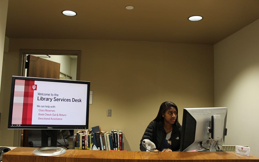 Sophomore Tyana Hendricks sits at the Herman B Wells Library&nbsp;west tower circulation desk. Hendricks worked from 3 to 8 a.m Wednesday morning and works three other overnight shifts every week.&nbsp;