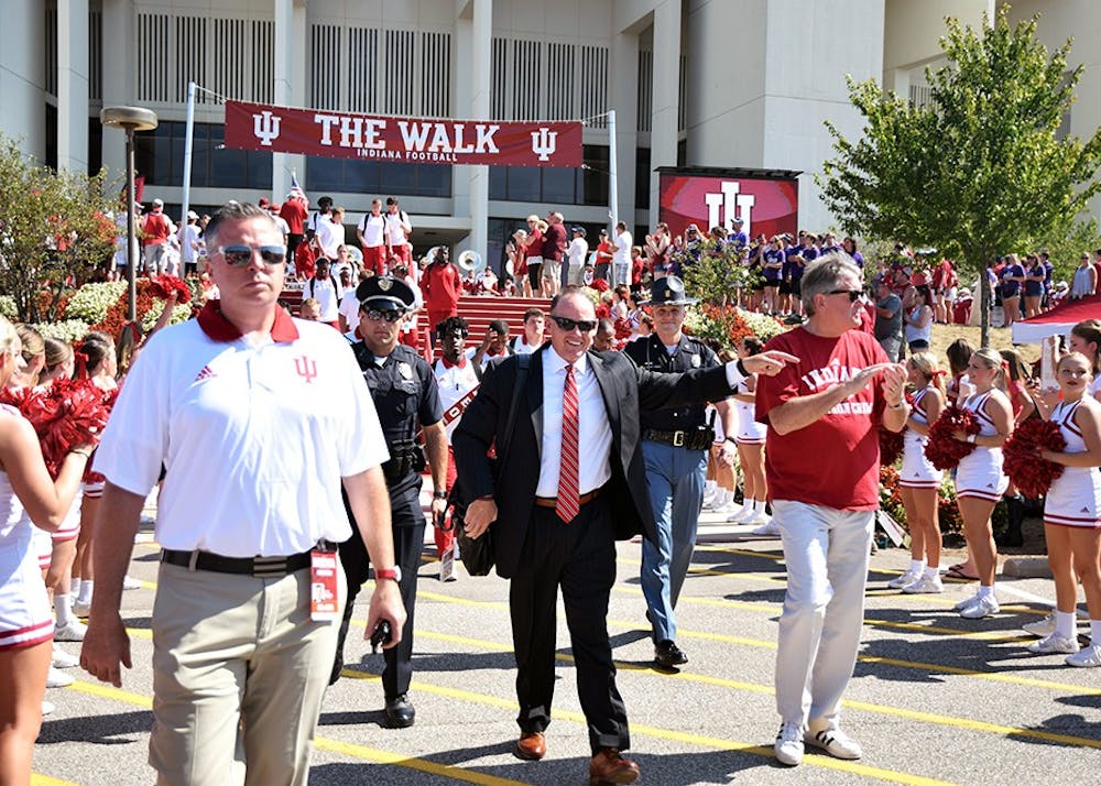 <p>Coach Tom Allen and Athletics Director Fred Glass walk down "The Walk" prior to the Indiana football game on Sept. 23, 2017. IU will open up home play on Saturday against Virginia.</p>